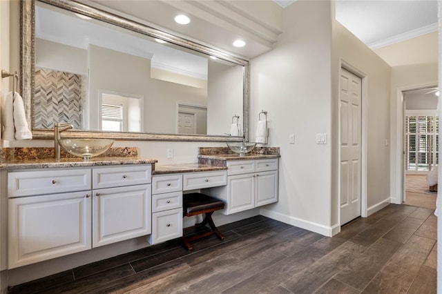 full bathroom featuring vanity, wood finished floors, baseboards, recessed lighting, and ornamental molding