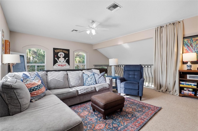 living room featuring visible vents, carpet floors, ceiling fan, and vaulted ceiling