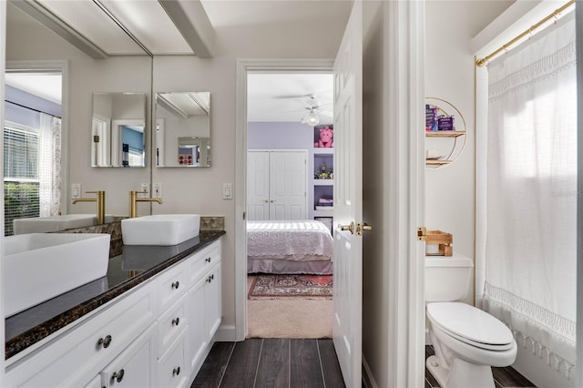 full bathroom featuring vanity, wood finished floors, ceiling fan, ensuite bathroom, and toilet