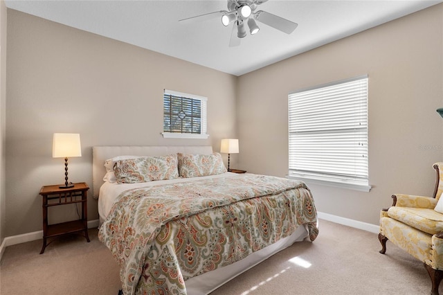 carpeted bedroom featuring baseboards and ceiling fan