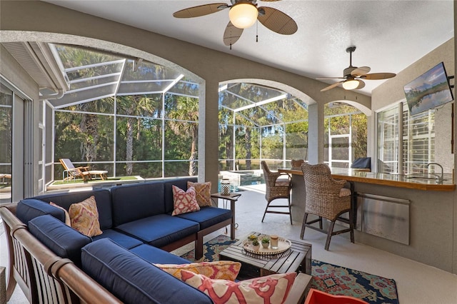 sunroom featuring a sink and ceiling fan