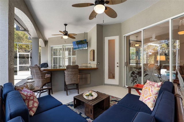 living area with a ceiling fan