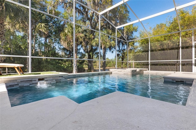 pool with glass enclosure and a patio area