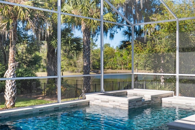 view of swimming pool featuring a lanai, a fenced in pool, an in ground hot tub, and fence