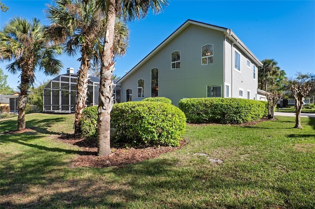 view of property exterior featuring stucco siding and a yard