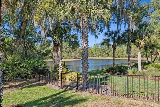 view of yard with a water view and fence