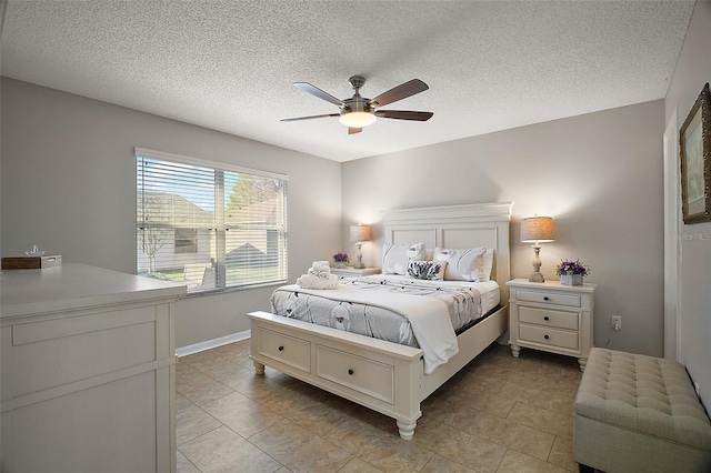 bedroom with light tile patterned floors, a textured ceiling, and ceiling fan
