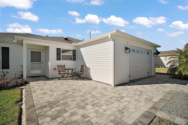 garage featuring decorative driveway