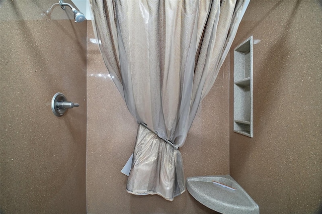 details featuring a shower and stucco siding