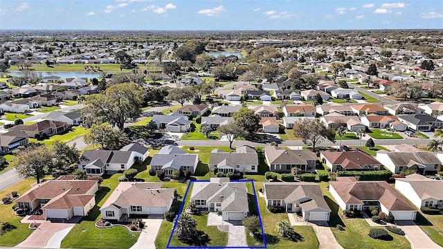 birds eye view of property featuring a residential view and a water view
