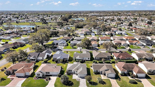 drone / aerial view featuring a residential view and a water view
