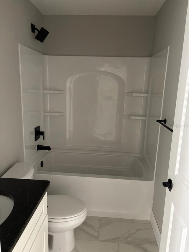 bathroom featuring vanity, toilet, marble finish floor, and  shower combination