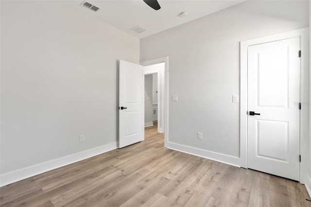 unfurnished bedroom with ceiling fan, visible vents, baseboards, and light wood-style flooring