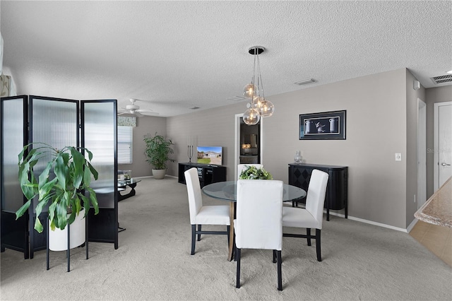 dining room featuring visible vents, a textured ceiling, a ceiling fan, and carpet floors