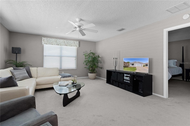 living area with visible vents, a ceiling fan, and carpet flooring