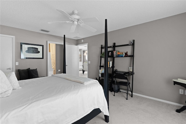 bedroom featuring visible vents, light carpet, a textured ceiling, baseboards, and ceiling fan