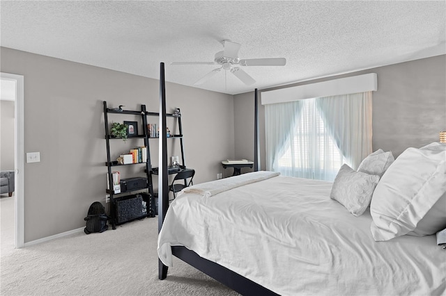 carpeted bedroom with baseboards, a textured ceiling, and ceiling fan