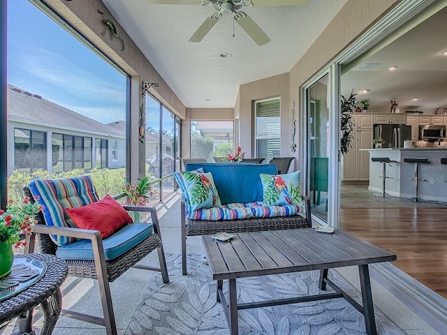 sunroom / solarium with visible vents and a ceiling fan