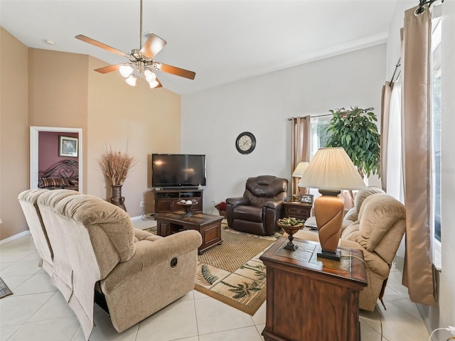 living area featuring ceiling fan and light tile patterned flooring