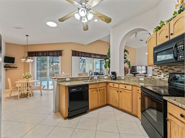 kitchen with light tile patterned floors, visible vents, a sink, and black appliances