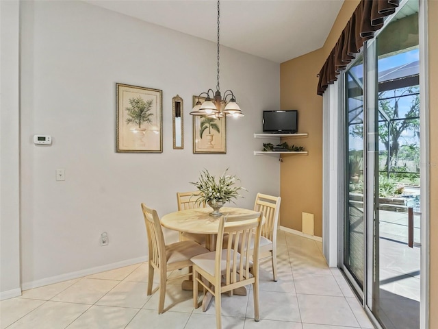 dining room featuring a chandelier, light tile patterned floors, and baseboards