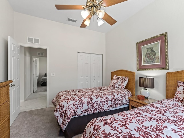 bedroom with visible vents, a closet, and light carpet