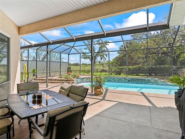view of patio / terrace featuring an outdoor pool, outdoor dining space, and glass enclosure