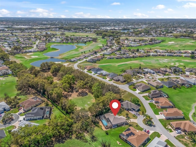 birds eye view of property featuring golf course view, a residential view, and a water view
