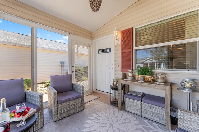 sunroom / solarium with a healthy amount of sunlight and lofted ceiling