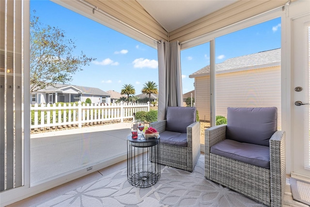 sunroom / solarium featuring a residential view