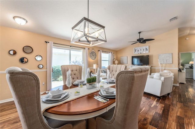 dining area with visible vents, dark wood-type flooring, ceiling fan, and vaulted ceiling