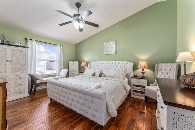 bedroom featuring lofted ceiling, dark wood finished floors, and a ceiling fan