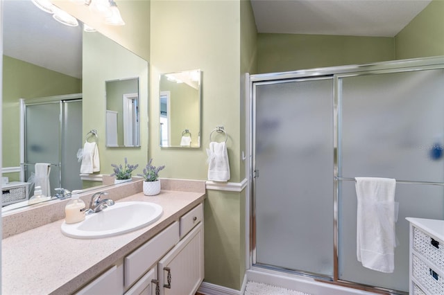 bathroom with vanity and a stall shower