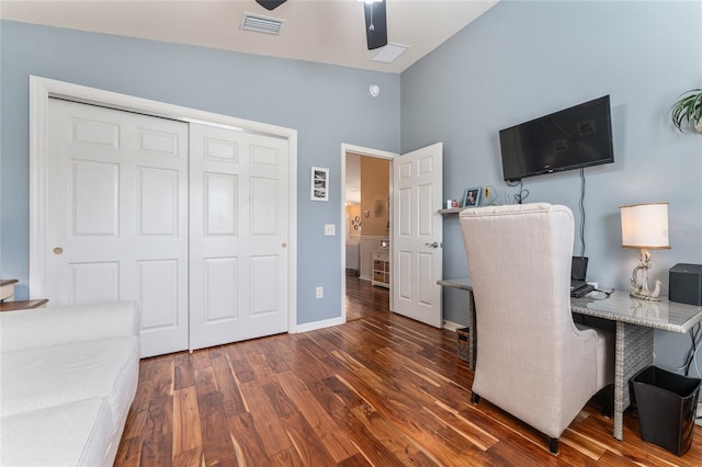 office space featuring a ceiling fan, wood finished floors, visible vents, baseboards, and lofted ceiling