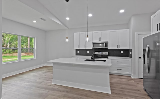 12444 SW 76th Ln, Dunnellon, FL 34432 - kitchen featuring appliances with stainless steel finishes, light countertops, white cabinets, backsplash, and lofted ceiling