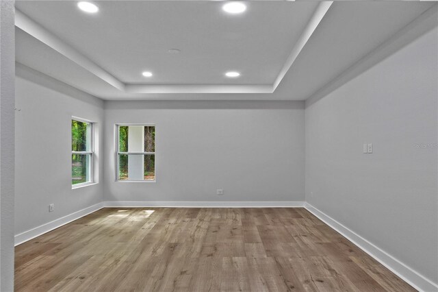 12444 SW 76th Ln, Dunnellon, FL 34432 - empty room with a raised ceiling, recessed lighting, and wood finished floors