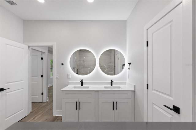 12444 SW 76th Ln, Dunnellon, FL 34432 - full bathroom featuring double vanity, wood finished floors, and a shower