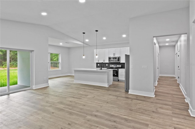 12444 SW 76th Ln, Dunnellon, FL 34432 - kitchen with appliances with stainless steel finishes, open floor plan, recessed lighting, white cabinetry, and light wood-type flooring