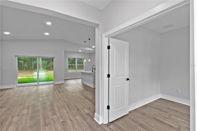 12444 SW 76th Ln, Dunnellon, FL 34432 - hallway featuring light wood-style floors, lofted ceiling, and recessed lighting