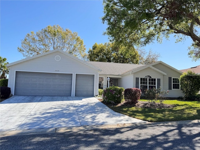 single story home featuring driveway and an attached garage