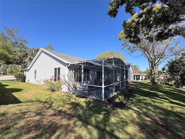 rear view of house featuring a lawn