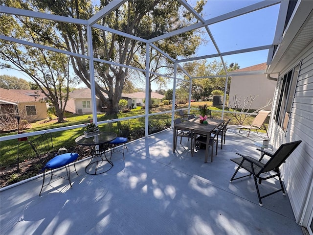 view of patio / terrace with glass enclosure and outdoor dining area