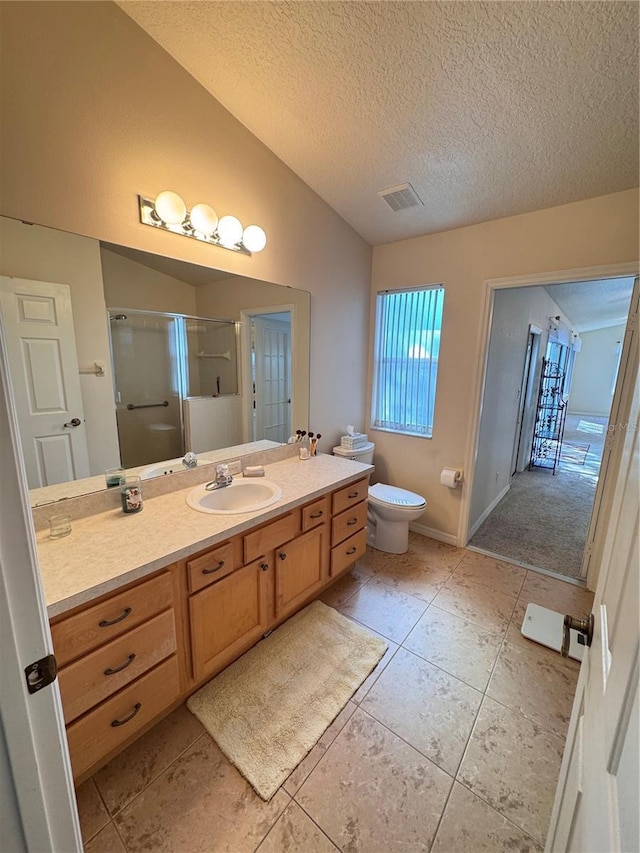 full bath featuring visible vents, toilet, a shower stall, lofted ceiling, and vanity