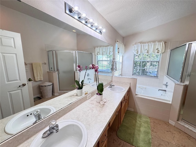 bathroom featuring a sink, a textured ceiling, and a stall shower