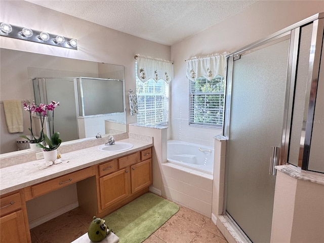 full bathroom featuring tile patterned floors, a garden tub, a stall shower, a textured ceiling, and vanity