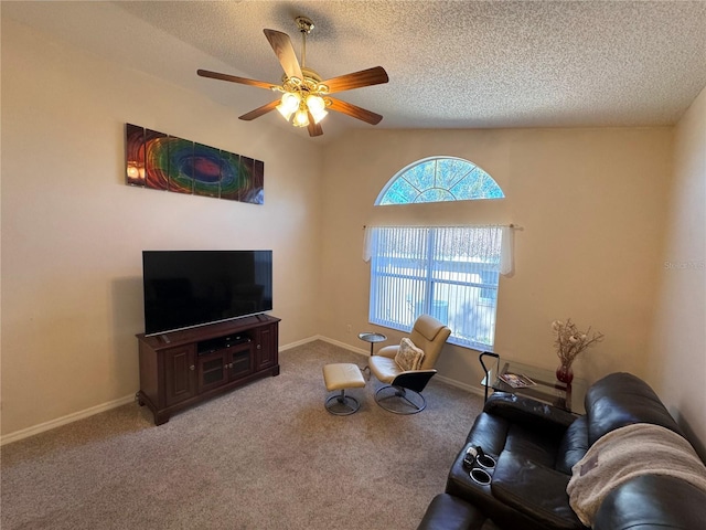 carpeted living area with a textured ceiling, lofted ceiling, baseboards, and ceiling fan