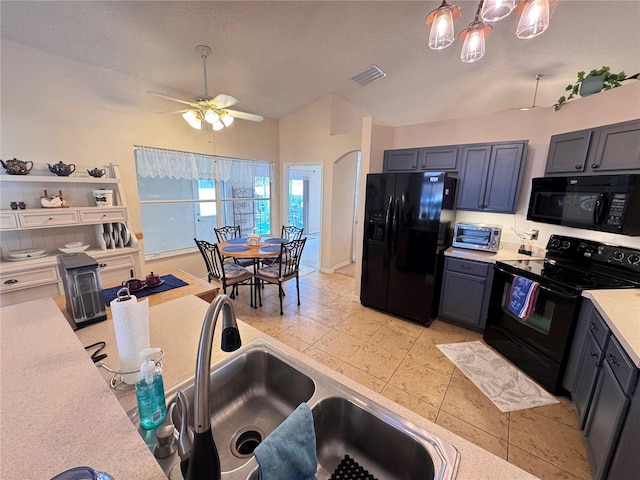 kitchen with black appliances, a sink, light countertops, light tile patterned floors, and ceiling fan