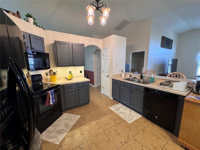 kitchen with black appliances, a sink, arched walkways, light countertops, and light tile patterned floors