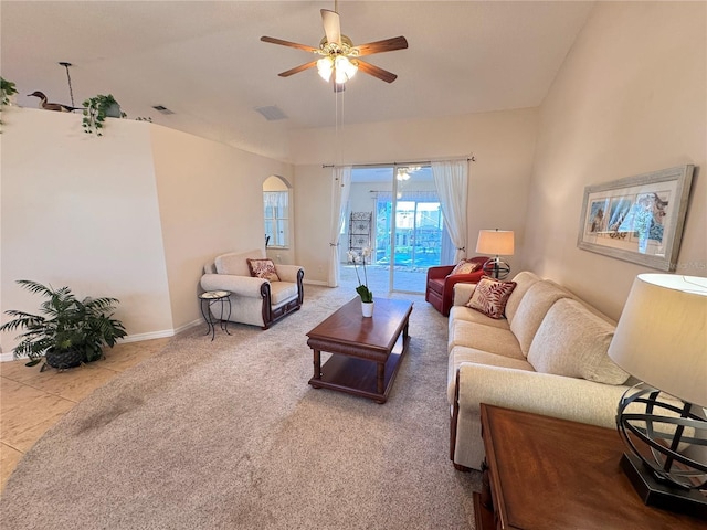 tiled living area featuring visible vents, baseboards, carpet floors, and ceiling fan