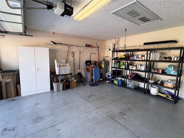 garage with a garage door opener and electric water heater